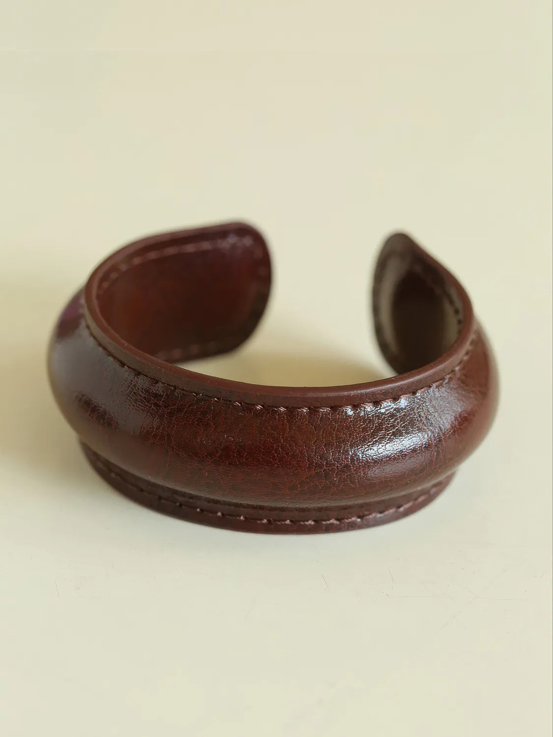 Brown leather cuff on a beige background